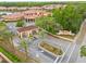 Aerial view of the community entrance, featuring lush landscaping and clear signage at 2608 Roadster Ln, Kissimmee, FL 34746