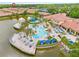 Stunning aerial view of the community pool area with water slides, cabanas and beautiful landscaping at 2608 Roadster Ln, Kissimmee, FL 34746