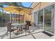 Outdoor dining area with a grill and views of the screened-in lanai, perfect for entertaining guests at 2608 Roadster Ln, Kissimmee, FL 34746