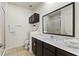 Bathroom featuring dark wood cabinets, white countertop and backsplash at 2608 Roadster Ln, Kissimmee, FL 34746