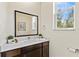 Well-lit powder room, modern vanity, and contemporary mirror and fixtures in the bathroom at 2608 Roadster Ln, Kissimmee, FL 34746