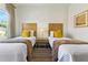 The twin bedroom features a side table between the beds at 2608 Roadster Ln, Kissimmee, FL 34746