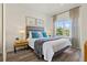 This bedroom features a large window, sleek headboard, and two side tables with lamps at 2608 Roadster Ln, Kissimmee, FL 34746