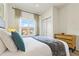 The bedroom showcases neutral tones, a side table, and a closet at 2608 Roadster Ln, Kissimmee, FL 34746