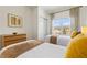 This bedroom showcases two beds, a wooden dresser, and a bright window at 2608 Roadster Ln, Kissimmee, FL 34746
