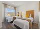 A well-lit bedroom has two twin beds, each with a side table and lamp at 2608 Roadster Ln, Kissimmee, FL 34746