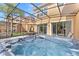 Relaxing hot tub with a screened-in lanai offering privacy and seamless indoor-outdoor living at 2608 Roadster Ln, Kissimmee, FL 34746
