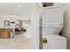Convenient laundry area featuring a stacked washer and dryer, open to the kitchen, living, and dining area at 2608 Roadster Ln, Kissimmee, FL 34746