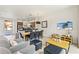 Bright, open-plan living area showcasing modern furniture, a TV, and easy access to the dining and kitchen at 2608 Roadster Ln, Kissimmee, FL 34746