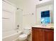 Cozy bathroom featuring a single vanity, toilet and a shower-tub combination at 2651 Andros Ln, Kissimmee, FL 34747