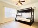 Bedroom features a fan and light fixture, plus a bunk bed and large window for natural light at 2651 Andros Ln, Kissimmee, FL 34747
