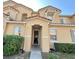 Inviting home entrance with well-manicured landscaping and neutral exterior paint scheme at 2651 Andros Ln, Kissimmee, FL 34747