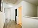 Hallway with wood flooring and a conveniently located laundry closet at 2651 Andros Ln, Kissimmee, FL 34747