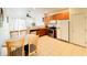 Bright kitchen features wood cabinets, stainless steel appliances, and an adjacent dining area at 2651 Andros Ln, Kissimmee, FL 34747