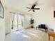Cozy living room area with sliding glass doors, tile floors, and a ceiling fan at 2651 Andros Ln, Kissimmee, FL 34747