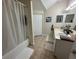 Bright bathroom featuring double sinks, a bathtub with shower, and neutral tile at 2964 Lucayan Harbour Circ # 106, Kissimmee, FL 34746