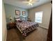 Comfortable bedroom with a patterned quilt, side tables, and ample natural light at 2964 Lucayan Harbour Circ # 106, Kissimmee, FL 34746