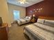 Spacious bedroom with two beds, colorful wall decor, and a ceiling fan at 2964 Lucayan Harbour Circ # 106, Kissimmee, FL 34746
