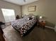 Comfortable bedroom with a patterned quilt, side tables, and ample natural light at 2964 Lucayan Harbour Circ # 106, Kissimmee, FL 34746