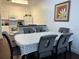 Open dining room featuring modern table and chairs, open to kitchen with white cabinetry at 2964 Lucayan Harbour Circ # 106, Kissimmee, FL 34746
