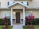 Inviting condo entrance with a well-maintained lawn, covered porch, and attractive front door at 2964 Lucayan Harbour Circ # 106, Kissimmee, FL 34746