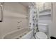 Bathroom with toilet and bathtub with shower head and shower curtain and open shelving at 3012 S Semoran Blvd # 3, Orlando, FL 32822