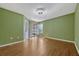 Bedroom with light hardwood floors, light-colored walls, a window, and sliding door at 3012 S Semoran Blvd # 3, Orlando, FL 32822