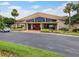 Community clubhouse with expansive windows, mature landscaping, and convenient parking for residents at 3012 S Semoran Blvd # 3, Orlando, FL 32822