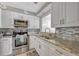 Updated kitchen featuring granite countertops, stainless steel appliances, and white cabinetry at 3012 S Semoran Blvd # 3, Orlando, FL 32822
