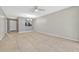 Open-concept living area with neutral walls, tile flooring, and a pass-through to the kitchen at 3012 S Semoran Blvd # 3, Orlando, FL 32822