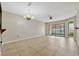 Spacious living room with tile flooring, neutral walls, and sliding glass doors to a private patio at 3012 S Semoran Blvd # 3, Orlando, FL 32822
