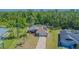 Aerial view of a lovely property with a manicured lawn, mature trees, and a private setting at 3394 Hawkin Dr, Kissimmee, FL 34746