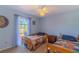 Bright bedroom with two twin beds, carpet, and a window providing ample natural light at 3394 Hawkin Dr, Kissimmee, FL 34746
