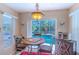 Cozy dining area with views of the pool, an elegant chandelier, and cafe-themed decor at 3394 Hawkin Dr, Kissimmee, FL 34746