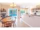 The dining area is brightly lit and features tile floors, chandelier, and views of the pool at 3394 Hawkin Dr, Kissimmee, FL 34746