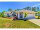 Charming single-Gathering home with a well-manicured lawn, mature landscaping, and a screened entrance at 3394 Hawkin Dr, Kissimmee, FL 34746