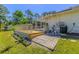 The rear of the home featuring a deck, an A/C unit, and access to the screened in pool at 3394 Hawkin Dr, Kissimmee, FL 34746