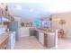 Spacious kitchen with stainless steel appliances and a breakfast bar overlooking the living room at 3394 Hawkin Dr, Kissimmee, FL 34746