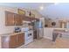 Cozy kitchen with brown cabinets, modern appliances, tile floors, and natural light at 3394 Hawkin Dr, Kissimmee, FL 34746
