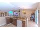 Open kitchen featuring tile floors, stainless steel sink, and breakfast bar area for casual dining at 3394 Hawkin Dr, Kissimmee, FL 34746