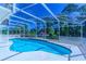 Relaxing screened-in pool area, perfect for enjoying the outdoors and features a clear blue pool at 3394 Hawkin Dr, Kissimmee, FL 34746