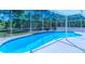 View of the backyard pool area showing the surrounding trees and landscaping at 3394 Hawkin Dr, Kissimmee, FL 34746