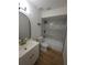 Modern bathroom featuring a stylish vanity, new fixtures, sleek black accents, a modern bathtub and tiled floors at 3504 Portersfield Rd, Orlando, FL 32808