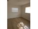 Bright and airy bedroom with natural light and wood-look floors at 3504 Portersfield Rd, Orlando, FL 32808