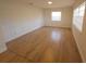 Bedroom with hardwood floor, trim and large window at 3504 Portersfield Rd, Orlando, FL 32808