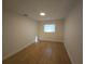 Comfortable bedroom featuring a hardwood floor and a window at 3504 Portersfield Rd, Orlando, FL 32808
