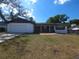 Charming one-story home featuring a well-maintained lawn and attached two-car garage at 3504 Portersfield Rd, Orlando, FL 32808