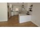 Open kitchen with white cabinets, quartz countertops, stainless sink and wood floors at 3504 Portersfield Rd, Orlando, FL 32808