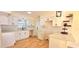 Modern kitchen featuring white cabinets, stainless steel appliances, quartz countertops, and hardwood floors at 3504 Portersfield Rd, Orlando, FL 32808