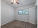 This carpeted bedroom contains a window, door, and open view at 4121 Caywood Cir, Orlando, FL 32810
